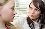 Woman and daughter frowning to each other