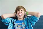 Teenage boy listening to music and looking excited