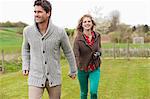 Couple holding hands in a field