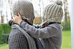 Man and son covering their faces with hats