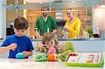 Boy and his sister playing with woolen balls