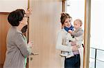 Woman with her daughter standing at the doorway