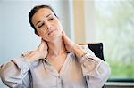 Close-up of a businesswoman suffering from neckache