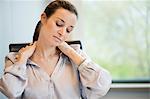 Close-up of a businesswoman suffering from neckache