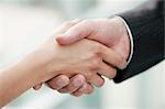 Close-up of business executives shaking hands in an office
