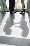Shadow of two business executives shaking hands