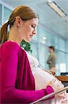 Pregnant woman sitting in the office