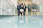 Business executives walking in a corridor