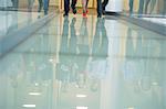 Reflection of business executives on the glassy floor