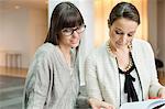 Two businesswomen discussing in an office