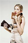 Young woman biting chocolate