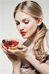 Young woman holding fresh fruit tart