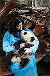 Woman holding 6 month old Giant Panda at Chengdu Panda Breeding Research Center