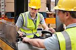 Men with machinery in warehouse