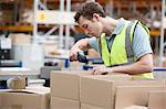 Man using barcode reader in warehouse