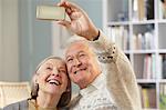 Senior couple using camera phone