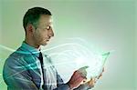 Businessman using digital tablet with lights