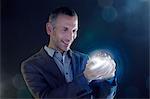 Businessman holding a ball of light