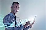 Businessman using digital tablet with lights