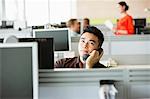 Young man on telephone in office