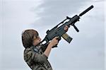 Boy Aiming Gun into the Air