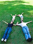 asian family lying on the grass