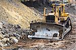 Bulldozer machine doing earthmoving work in mining