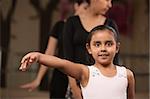 Cute young ballet student practicing in a dance studio