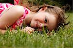 Cute little girl on the meadow in spring day