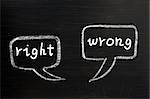 Two speech bubbles for right and wrong written with white chalk on a blackboard