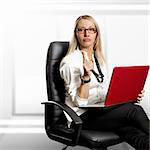 Business woman in leather chair, looking on camera