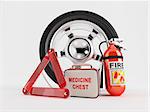 A set consisting of a wheel, fire extinguisher, first aid kit and warning triangle