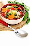 Summer vegetable soup in a bowl on a white background.