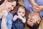 Mixed Race Family Playing Face Up on the Blanket.