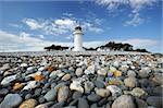 lighthouse in Denmark with stones in the foreground lighthouse called sletterhage