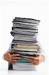 Female hands holding pile of paperworks, over white background