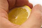 fresh ripe lemon cutted in half hold in hand closedup