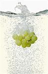 Grapes falling into champagne