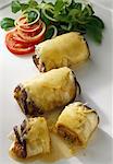 Aubergine rolls filled with minced beef and button mushrooms