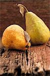 Two pears on a wooden surface