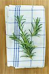 Rosemary sprigs on a tea towel