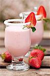 Strawberry smoothie in glasses with a sugared rim