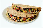 Two Vegetarian Tacos on Multi-Grain Tortillas; White Background