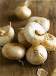 Whole White Onions on Wooden Table