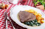 Boiled beef fillet with fried potatoes and spinach