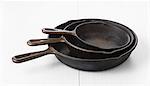 Three iron pans in different sizes