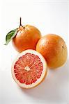 Pink grapefruits, whole and halved