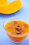 Pumpkin soup in a glass bowl with croutons