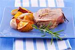 A slice of turkey roulade with rosemary and a side of vegetables