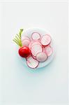 A whole radish and sliced radishes